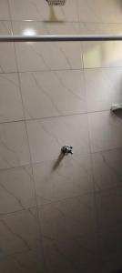 a shower stall with a faucet in a bathroom at Café y sueños Cabaña Jacuzi externo in Silvania +34 photos
