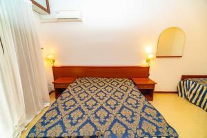 Giường trong phòng chung tại Rifugio Manaccora - Appartamento con piscina, parcheggio e mare