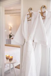 a white robe hanging on a rack in a room at Posada Arenas in José Ignacio +22 photos