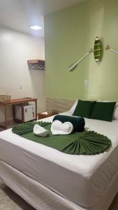 ein großes Bett mit zwei Kissen darauf in der Unterkunft Pousada Banzeiro Marajó in Soure