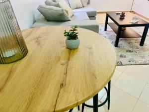 a wooden table with a potted plant on top of it at Le bon coin in Casablanca
