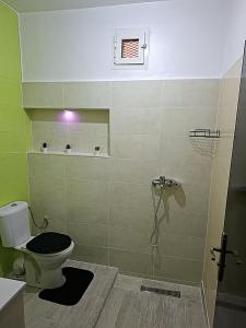 a bathroom with a toilet and a shower at Le bon coin in Casablanca +8 photos