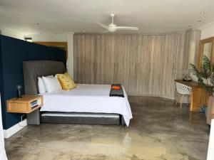a bedroom with a bed and a blue wall at RElaxed city living in Port Elizabeth +153 photos