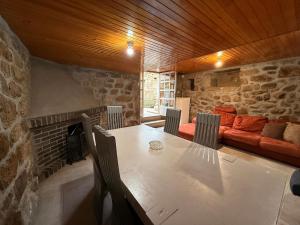 een eetkamer met een tafel en een bank bij A Casiña de Coles in Gustey