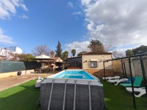 a backyard with a swimming pool and a house at RURAL EL SANTISCAL in Arcos de la Frontera