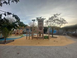a playground in a park with a clock tower at CaroCarnon in La Celle-sous-Gouzon