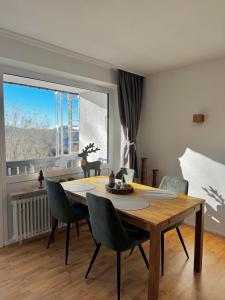 a dining room with a table and chairs and a window at FeWo Bergruh 922 im Ferienpark Oberallgäu in Missen-Wilhams
