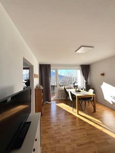 a living room with a table and a dining room at FeWo Bergruh 922 im Ferienpark Oberallgäu in Missen-Wilhams
