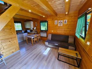 a living room with a couch and a table at Domki Mosorczyk in Zawoja