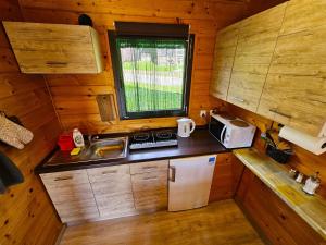 a small kitchen with a sink and a refrigerator at Domki Mosorczyk in Zawoja +25 photos