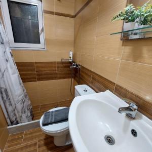 a bathroom with a sink and a toilet and a window at The Mastiha Spot 5 in Chios +51 photos