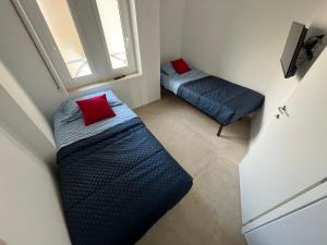 a small bedroom with two beds and a window at Capitan Ale in Sanremo +27 photos