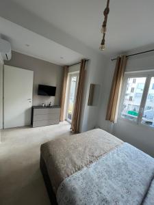 a bedroom with a bed and a flat screen tv at Capitan Ale in Sanremo