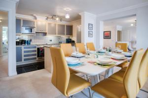 Una cocina y un comedor con una mesa y sillas blancas. en 13 St Brides Bay View - 4 Bedroom - Broad Haven, en Broad Haven