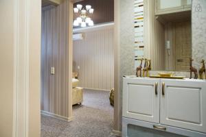 a bathroom with a white cabinet and a sink at Studio At Dnipro Naberezhnaya in Dnipro