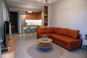 a living room with a couch and a table at VASIADIS apartment in Síndos
