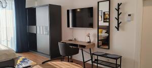 a bedroom with a desk and a mirror and a bed at Planet-A1012 in Niš