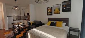 a bedroom with a bed and a small kitchen at Planet-A1012 in Niš
