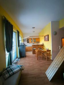 a living room and kitchen with a table and chairs at Hills View Apartment in Donovaly +28 photos