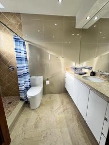 a bathroom with a toilet and a sink at Penthouse con vistas espectaculares del Lago de Atitlán in Panajachel +23 photos
