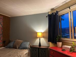 een slaapkamer met een bed en een tafel met een lamp bij The Allen House in North Adams +6 foto's