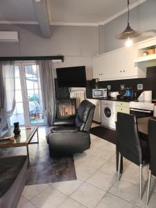 a living room with a couch and a table at jim villa in Andravída