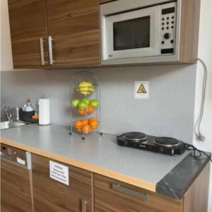 a kitchen with a counter top with a microwave at Auszeit in Hamburg +14 photos