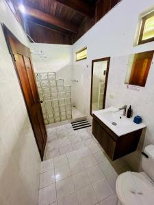 a bathroom with a sink and a toilet at Hotel Exotic Lodge in Puerto Viejo