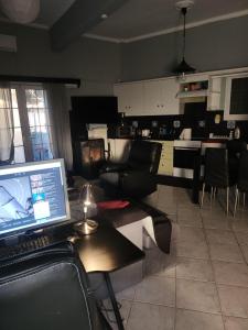 a living room with a laptop computer on a table at jim villa in Andravída +3 photos