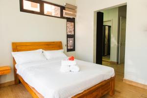 a bedroom with a bed with two towels on it at Paradis des Anges Appartement in Triolet