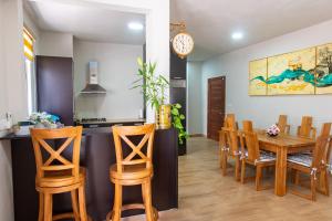 a kitchen and dining room with a table and chairs at Paradis des Anges Appartement in Triolet