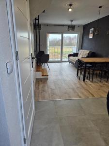 a living room with a couch and a table at Ostoja we Władku in Władysławowo +10 photos