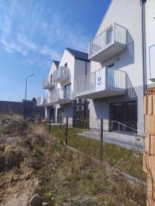 a white building with balconies on a beach at Ostoja we Władku in Władysławowo