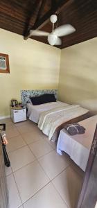 a bedroom with two beds and a ceiling at Pousada Paraíso Guapi in Guapimirim