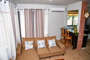 a living room with a couch and a table at Paradis des Anges Appartement in Triolet