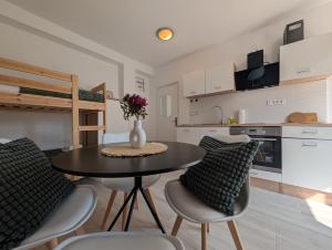 a kitchen and dining room with a table and chairs at Sesvete Studio 4 Four in Sesvete +20 photos