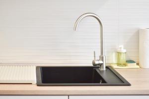 a kitchen sink with a faucet on a counter at Sesvete Studio 4 Four in Sesvete