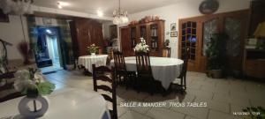 a dining room with a white table and chairs at Chambres D'hôtes Mongarny Cancale in Cancale