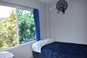 ein Schlafzimmer mit einem Bett und einem großen Fenster in der Unterkunft Finca el Paraiso Casa Loma, Tena in Tena + 68 Fotos