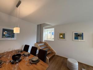 a dining room with a table and some chairs at Alpine Loft in Interlaken +12 photos