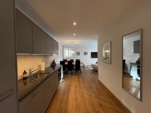 a kitchen with a dining room and a living room at Alpine Loft in Interlaken