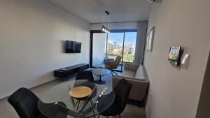 a living room with a couch and a table and chairs at STAY Engomi Gem 2 in İncirli