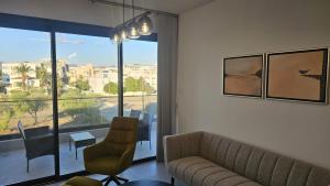 a living room with a couch and a table and a window at STAY Engomi Gem 2 in İncirli