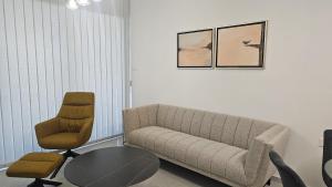 a living room with a couch and a table and a chair at STAY Engomi Gem 2 in İncirli