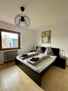 a bedroom with a large bed and a chandelier at Apartment 22 in Schlins