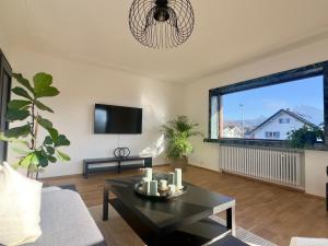 a living room with a coffee table and a large window at Apartment 22 in Schlins