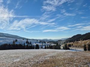 a large open field with snow on the ground at Luxusny apartman z tarasmi - Vera in Telgárt