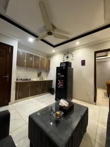 a kitchen with a table in the middle of a room at Stay Prime Apartments in Lahore