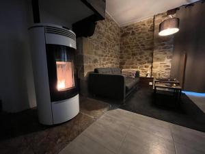 a living room with a fireplace and a couch at Le Domaine des Songes in Saint-Maden