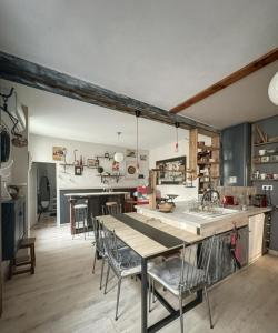 a kitchen and dining room with a table and chairs at Le Domaine de Cécile by Alto Service in Perpignan